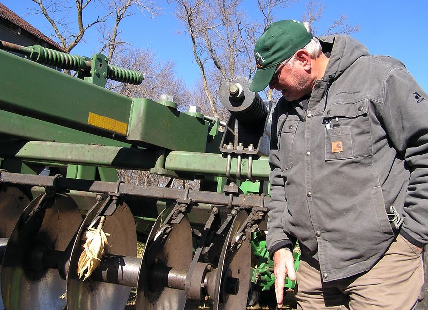 Southwest Minnesota farmer Michael Wojahn farms with his father near Windom, Minn., on Nov. 4, 2014. The end of fall harvest reveals disappointing yields for some Minnesota farmers, and with a big harvest expected nationally pushing soybean and crop prices lower, that means the economic outlook in Minnesota is cloudy. (AP Photo/Minnesota Public Radio, Mark Steil)