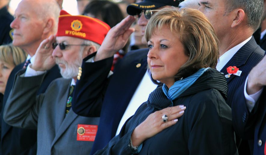 Gov. Susana Martinez holds her hand over her heart as the Pledge of Allegiance is recited during a Veterans Day ceremony at the New Mexico Veterans Memorial in Albuquerque, N.M., on Tuesday, Nov. 11, 2014. (AP Photo/Susan Montoya Bryan) ** FILE **