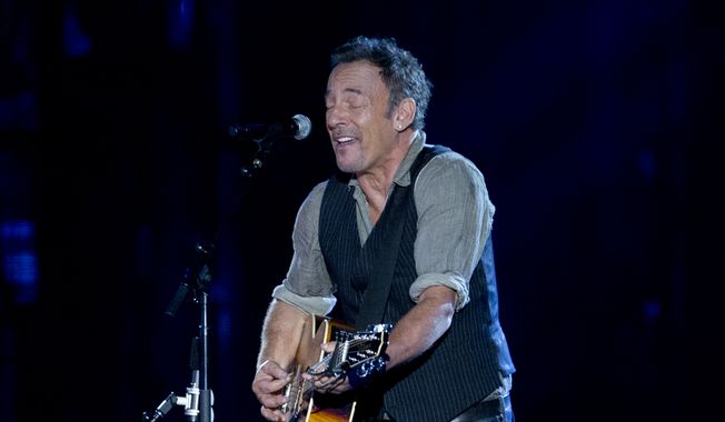 Bruce Springsteen performs on the National Mall in Washington, Tuesday, Nov. 11, 2014, during the Concert for Valor. The Veterans Day event is hosted by HBO, Starbucks and Chase and is free and open to the public. (AP Photo/Carolyn Kaster)