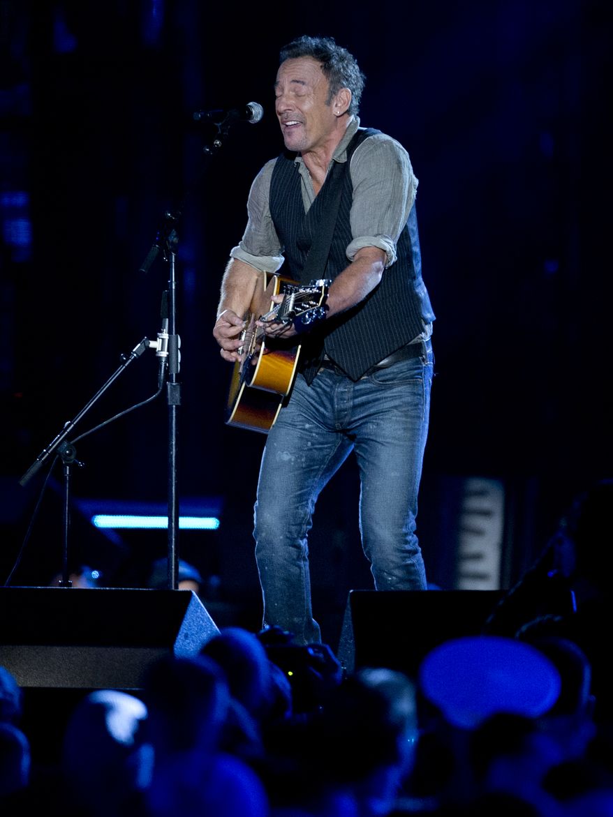 Bruce Springsteen performs on the National Mall in Washington, Tuesday, Nov. 11, 2014, during the Concert for Valor. The Veterans Day event is hosted by HBO, Starbucks and Chase and is free and open to the public. (AP Photo/Carolyn Kaster)