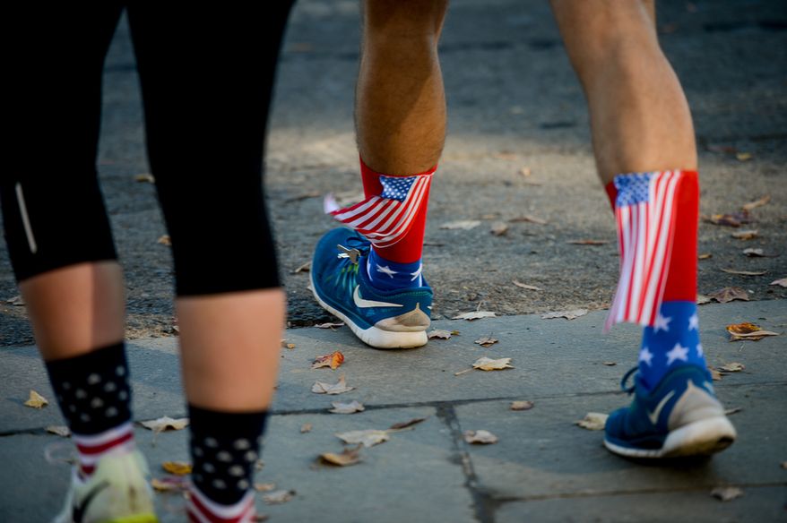 Michael Harold of Washington, D.C. wears American flag sox as he jogs on the National Mall on Veterans Day, Washington, D.C., Tuesday, November 11, 2014. (Andrew Harnik/The Washington Times)