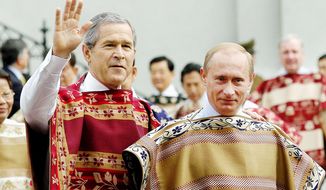 U.S. President Bush, left, and Russian President Vladimir Putin, wearing traditional Chilean ponchos, are seen prior to the leaders&#39; group photo at the 2004 APEC Summit in Santiago, Chile, Sunday, Nov. 21, 2004. (AP Photo/ITAR-TASS, Presidential Press Service) ** FILE **