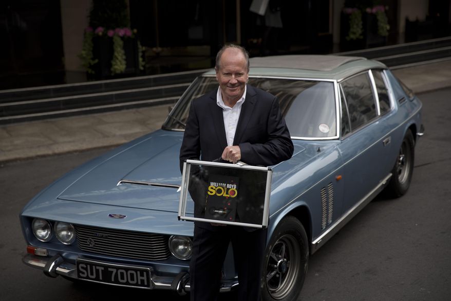FILE - In this Sept. 25, 2013, file photo, William Boyd, the author of the new James Bond novel "Solo" poses for photographers outside the Dorchester Hotel in London. Boyd's nearly 17,000-word story, "The Vanishing Game," comes out Wednesday, Nov. 12, 2014, as a free download through Amazon.com, Apple and www.thevanishinggame.com. (AP Photo/Matt Dunham, File)