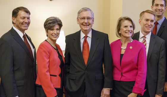 Senate Minority Leader Mitch McConnell of Ky., center, smiles as he welcomes some of the new GOP senators-elect in his office on Capitol Hill in Washington, Wednesday, Nov. 12, 2014. From left are, Sen.-elect Mike Rounds, R-S.D., Sen.-elect Joni Ernst, R-Iowa, Mitch McConnell, Sen.-elect Shelley Moore Capito, R-W.Va., Sen.-elect James Lankford, R-Okla., and Sen.-elect Tom Cotton, R-Ark. (AP Photo/J. Scott Applewhite)