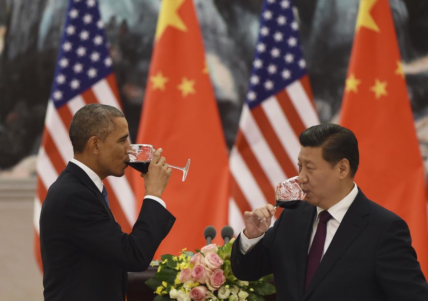 U.S. President Barack Obama, left, and Chinese President Xi Jinping drink a toast at a lunch banquet in the Great Hall of the People in Beijing Wednesday, Nov. 12, 2014. Obama is on a state visit after attending the Asia-Pacific Economic Cooperation summit. (AP Photo/Greg Baker, Pool)