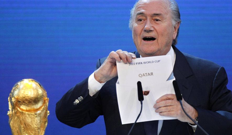 FILE - In this Thursday, Dec.2, 2010 file photo FIFA President Sepp Blatter announces Qatar to host the 2022 soccer World Cup in Zurich, Switzerland. FIFA has cleared Russia and Qatar of any wrongdoing in their winning bids for the next two World Cups. (AP Photo/Michael Probst)