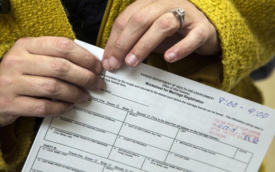 A woman holds an application for a marriage license at the Sedgwick County Courthouse in Wichita, Kan.,Thursday Nov. 13, 2014.  The U.S. Supreme Court denied a request Wednesday from the state to block gay and lesbian couples from getting married in Kansas while the state fights lawsuits challenging Kansas&#39; gay-marriage ban. (AP Photo/The Wichita Eagle, Mike Hutmacher)