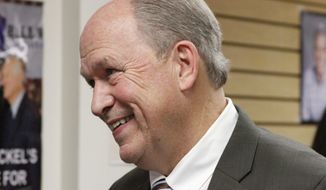 Bill Walker, an independent candidate for Alaska governor, is shown talking to a supporter after a news conference Wednesday, Nov. 12, 2014, in Anchorage, Alaska. Walker leads incumbent Republican Gov. Sean Parnell by about 4,000 votes with thousands of absentee ballots to be counted starting later this week. Walker held the news conference to discuss the transition process in case he wins. (AP Photo/Mark Thiessen)