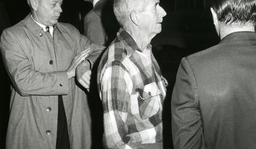 This 1969 photo shows LaVere Redfield, center, in Reno, Nev. Jack Harpster, a retired newspaperman and author of seven other books in the biography genre, has written a new book on Redfield. (AP Photo/The Reno Gazette-Journal, File)