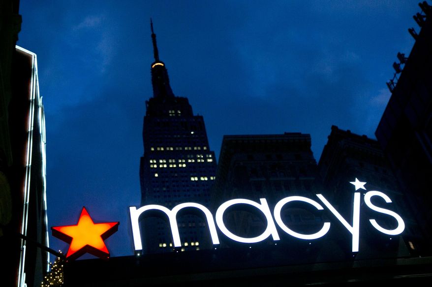 In this Nov. 21, 2013, photo, with the Empire State building in the background, the Macy&#x27;s logo is illuminated on the front of the department store in New York. (AP Photo/Mark Lennihan) ** FILE **