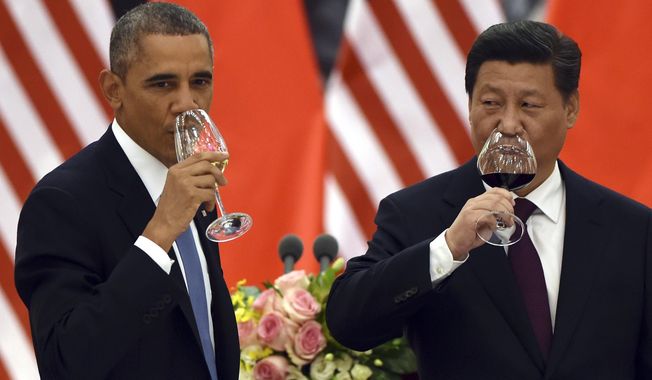 President Obama and Chinese President Xi Jinping drink after a toast during a lunch banquet in the Great Hall of the People in Beijing on Nov. 12, 2014. (Associated Press) **FILE**