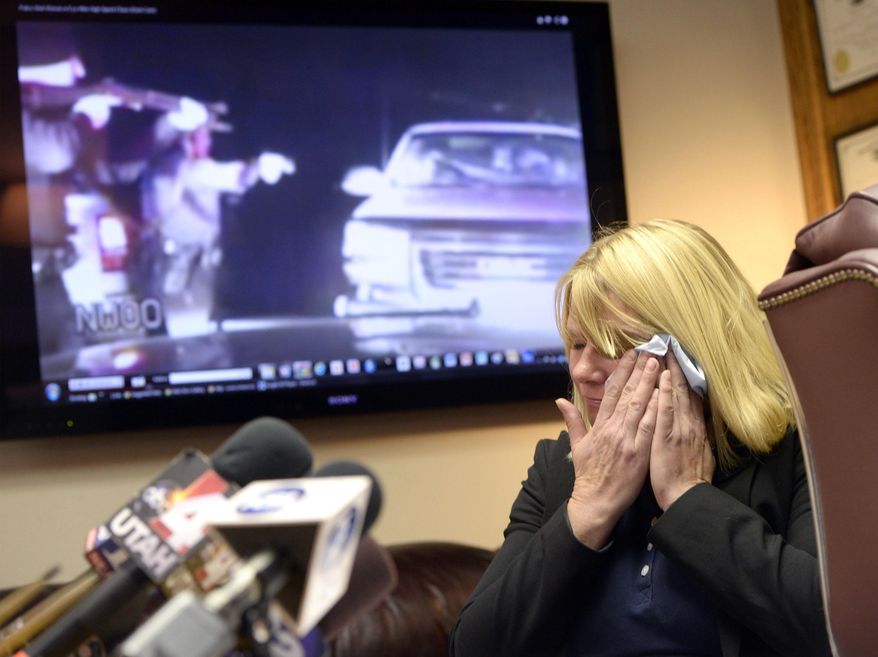 Kristine Biggs Johnson breaks down as her attorney Bob Sykes, plays a Youtube video from a law enforcement dashcam when she was shot in the eye November 2012.  Her attorney Bob Sykes is filing a federal civil rights lawsuit Thursday, Nov. 13, 2014,  against a Morgan County Sheriff’s deputy for improper use of deadly force against her. The shooting was deemed unjustified by Davis County Attorney Troy Rawlings, but no charges were filed against the deputy. (AP Photo/The Salt Lake Tribune, Al Hartmann)
