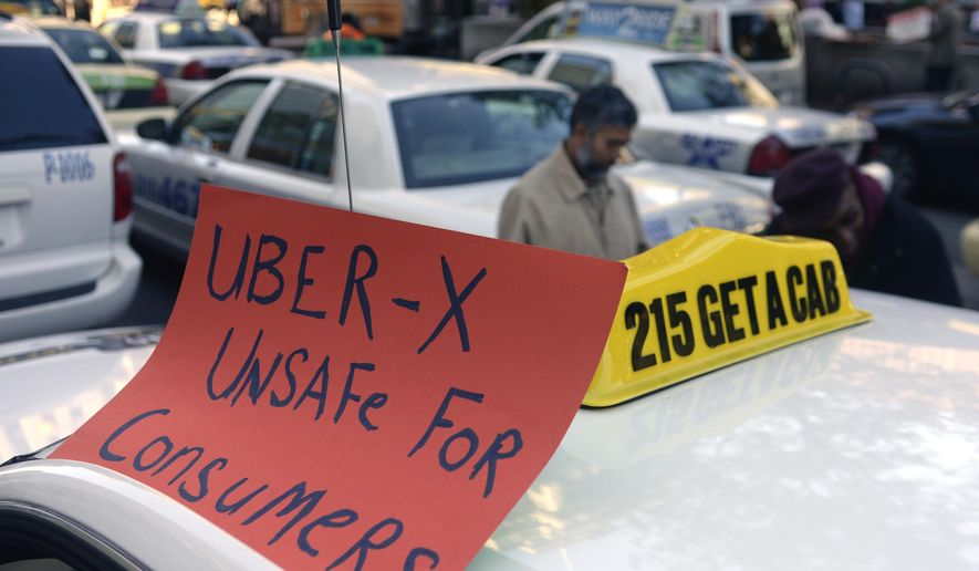 Drivers with the Taxi Workers Alliance of Pennsylvania protest on near Love Park in Philadelphia Oct. 8, 2014, as Uber and Lyft are making a concerted push to bring their ride-share services to Philadelphia. The state's Public Utility Commission is expected to vote Thursday Nov. 13, 2014 on Uber X's application to operate in many other parts of Pennsylvania. (AP Photo/Philadelphia Inquirer, Tom Gralish)