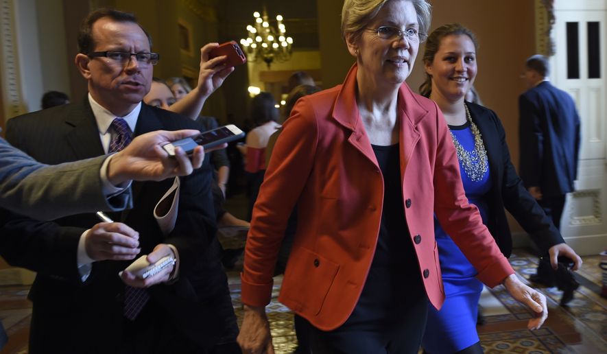 Sen. Elizabeth Warren, D-Mass. is pursued by reporters on Capitol Hill in Washington, Thursday, Nov. 13, 2014. Officials said Sen. Warren, a favorite of liberals, would be given a seat at the Democrats leadership table.  (AP Photo/Susan Walsh)