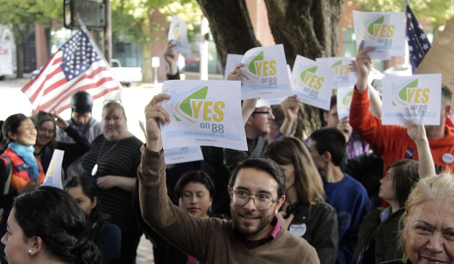 FILE - In this Oct. 13, 2014 file photo, a crowd of Measure 88 supporters wave signs during a rally in Portland, Ore. As President Obama moves toward taking action to allow millions of people in the country illegally to stay and possibly work, the outcome of a little-noticed ballot measure in deep-blue Oregon serves as a warning to him and his party on the volatility of the immigration issue. (AP Photo/Don Ryan, File)