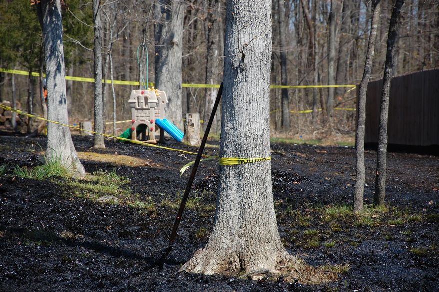 In this Monday, April 1, 2013 file photo, oil covers the ground around a slide in Mayflower, Ark., days after a pipeline ruptured and spewed oil over lawns and roadways. The Pegasus pipeline ruptured last March in Mayflower, spilling thousands of gallons of oil into the area. Exxon Mobil is denying claims from plaintiffs in an oil spill lawsuit that it made all information about the maintenance and repair of an oil pipeline secret. The oil giant has blamed the rupture on manufacturing defects. (AP Photo/Jeannie Nuss, File)