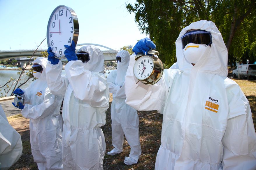 Protestors asking for world leaders to heed call to action in the fight against the killer ebola virus walk along the Brisbane river bank during the G-20 in Brisbane, Australia, Saturday, November 15, 2014. Brisbane is playing host to top officials from the 20 biggest industrialized and developing economies for a two day meeting from Saturday Nov.15. (AP Photo/Tertius Pickard)