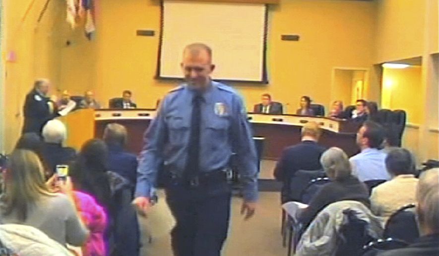 FILE - In this  Feb. 11, 2014 file image from video provided by the City of Ferguson, Mo., officer Darren Wilson attends a city council meeting in Ferguson. Police identified Wilson, 28, as the police officer who shot 18-year-old Michael Brown on Aug. 9, 2014 in Ferguson. Police departments across the country are bracing for large demonstrations when a grand jury decides whether to indict Wilson. (AP Photo/City of Ferguson, File)