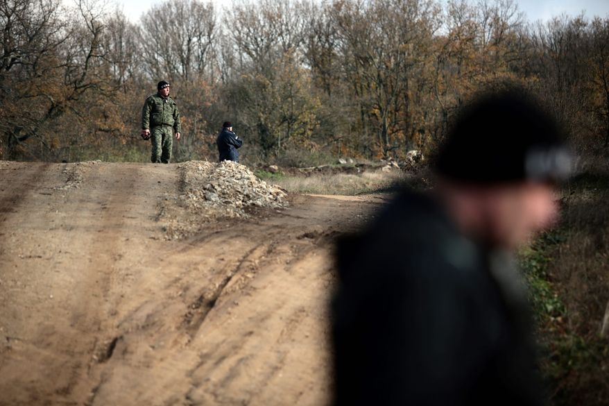 Border policemen stand guard at Bulgarian-Turkish border where many of the illegal immigrants enter in 2013. Bulgarian authorities built a 20-mile fence on its border with Turkey to prevent illegal entry. (Associated Press)