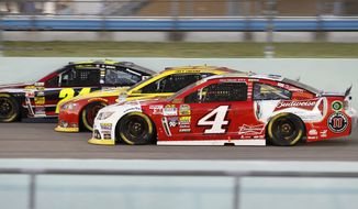 Jeff Gordon (24), Joey Logano (22) and Kevin Harvick race each other during the NASCAR Sprint Cup championship series auto race, Sunday, Nov. 16, 2014 in Homestead, Fla. (AP Photo/Terrry Renna)