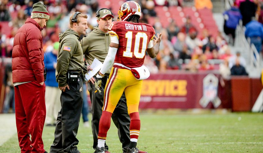 Washington Redskins quarterback Robert Griffin III (10) talks with Washington Redskins head coach Jay Gruden, second from right, and Washington Redskins offensive coordinator Sean McVay as the Washington Redskins play the Tampa Bay Buccaneers in NFL football at FedExField, Landover, Md., Sunday, November 16, 2014. (Andrew Harnik/The Washington Times)