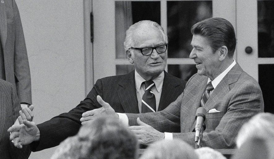 President Ronald Reagan, right, greets Sen. Barry Goldwater, R-Ariz., in the Rose Garden at the White House during a ceremony to start National Partiotism Week in Washington, D.C., Tuesday, Feb. 17, 1981.  (AP Photo/Charles Tasnadi)