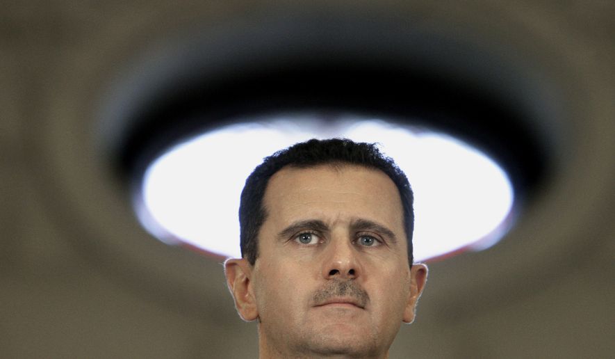 Syrian President Bashar Assad presents a snag in U.S.-Iran nuclear arms talks. (AP Photo/Vadim Ghirda)