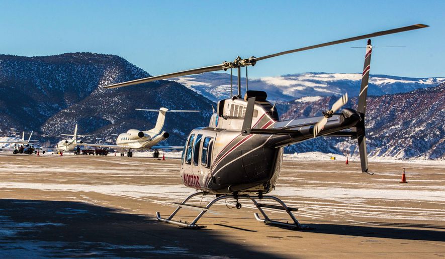 This undated image provided by Beaver Creek Resort shows a helicopter at Eagle Vail Airport in Colo. A private helicopter is part of a $50,000 white-glove package for four offered by the resort that includes season passes to 22 mountains owned by or partnered with Vail Resorts, first-class airfare from within the U.S., ski equipment and lessons, and five nights at a cabin with concierge and chef. (AP Photo/Beaver Creek)