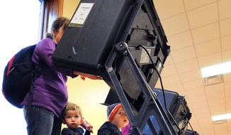 Jackson, left, and Jacob Sanchez, 2, wait while their mother, Jana Sanchez, votes on Election Day, Tuesday, Nov. 4, 2014, in Salina, Kan. Sanchez said she wasn&#39;t sure how bringing her two year old sons with her to vote would go, &quot;but it was fun.&quot; (AP Photo/Salina Journal, Tom Dorsey)