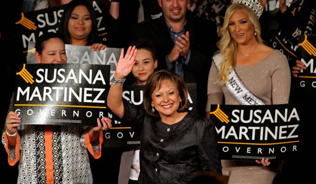 New Mexico Gov. Susana Martinez waves to her supporters upon her arrival to the victory party on election night in Albuquerque, N.M., Tuesday, Nov. 4, 2014. Republican Susana Martinez was re-elected beating Democratic challenger Gary King. (AP Photo/Andres Leighton)