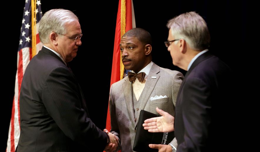 Missouri Gov. Jay Nixon (left) meets with Rev. Starsky Wilson (center) and Rich McClure (right) after swearing the two men in as co-chairs of the 16-member Ferguson Commission in St. Louis Tuesday. The independent commission has been created to study issues that have surfaced since the fatal police shooting of Michael Brown. (Associated Press)