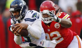 Kansas City Chiefs nose tackle Dontari Poe (92) sacks Seattle Seahawks quarterback Russell Wilson (3) in the second half of an NFL football game in Kansas City, Mo., Sunday, Nov. 16, 2014. The Chiefs won 24-20. (AP Photo/Ed Zurga)