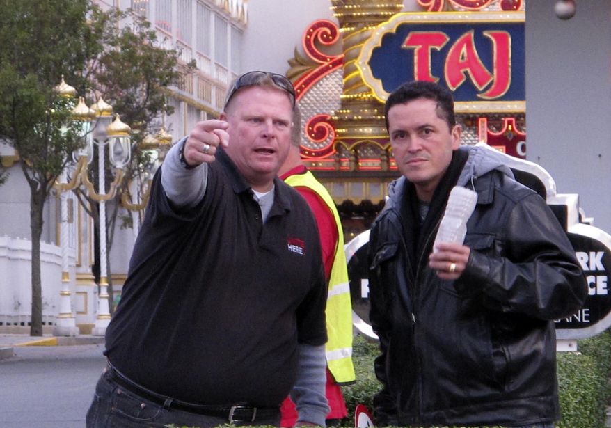 In this photo taken on Oct. 24, 2014, Robert McDevitt, left, president of Local 54 of the Unite-HERE casino workers union, gestures at a protest outside the Trump Taj Mahal Casino Resort in Atlantic City, N.J. The union planned another protest outside the casino on Wednesday, Nov. 19, 2014, the same day that Trump Entertainment Resorts CEO Bob Griffin compared McDevitt to Russian dictator Joseph Stalin. (AP Photo/Wayne Parry)