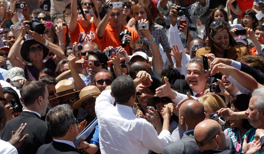 President Obama is mobbed by a crowd following a speech on immigration reform at Chamizal National Memorial Park in El Paso, Texas. [Associated Press]