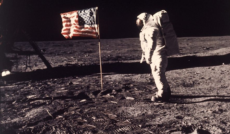 A July 20, 1969 photo from files made showing astronaut Edwin E. Buzz Aldrin Jr. posing for a photograph beside the U.S. flag deployed on the moon during the Apollo 11 mission. (AP Photo/NASA/Neil A. Armstrong, File) ** FILE **