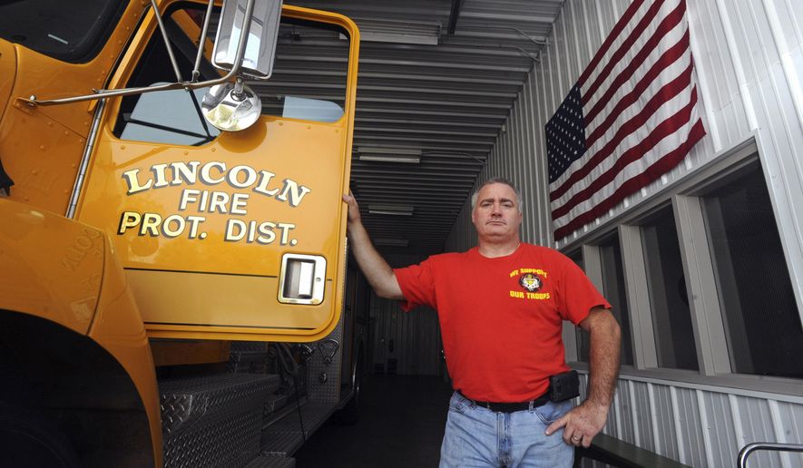 In this Oct. 23, 2014 photo, Rob Ratliff, the Fire Chief at Lincoln Fire Protection District Station No. 2, poses for a photo at the station in small town of Lerna, Ill. Ratliff knows a few things about the small town he's spent most of his life in, beginning in 1979. (AP Photo/Journal Gazette, Kevin Kilhoffer)