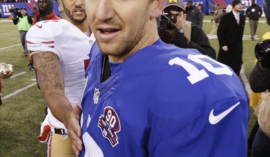 New York Giants quarterback Eli Manning (10) leaves the field after talking to San Francisco 49ers&#x27; Colin Kaepernick (7) after an NFL football game Sunday, Nov. 16, 2014, in East Rutherford, N.J. The 49ers won the game 16-10. (AP Photo/Julio Cortez)