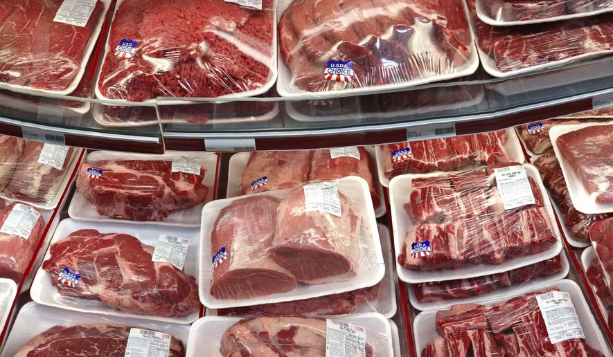 FILE - In this Nov. 2, 2013 file photo, various cuts of beef and pork are displayed for sale in the meat department at a discount market in Arlington, Va. The U.S. is running out of options to keep package labels on fresh cuts of meat that identify where animals were born, raised and slaughtered. The World Trade Organization has ruled that those labels discriminate against Canada and Mexico. (AP Photo/J. Scott Applewhite, File)