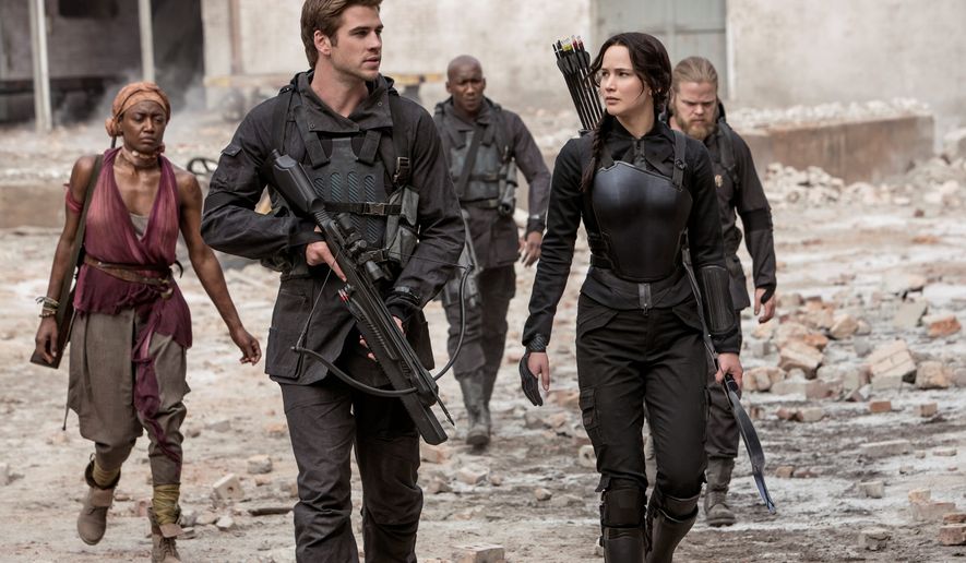 Jennifer Lawrence stars as Katniss Everdeen with Liam Hemsworth as Gale Hawthorne in &quot;The Hunger Games: Mockingjay Part 1.&quot; There&#39;s a lot that doesn&#39;t add up in the latest entry from the first half of the final book in the series of popular young adult novels. (Lionsgate via Associated Press)