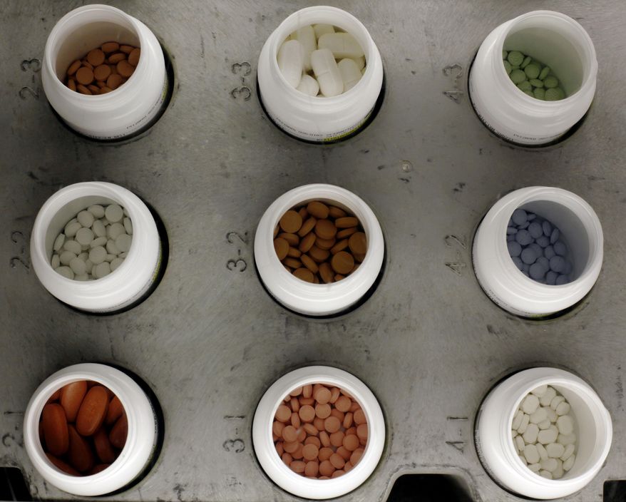 FILE - This June 14, 2011 file photo shows various prescription drugs on the automated pharmacy assembly line at Medco Health Solutions, in Willingboro, N.J. Some low-cost generic drugs that have helped restrain health care costs for decades are seeing unexpected price spikes of up to 8,000 percent, prompting a backlash from patients, pharmacists and now Washington lawmakers. (AP Photo/Matt Rourke, File)