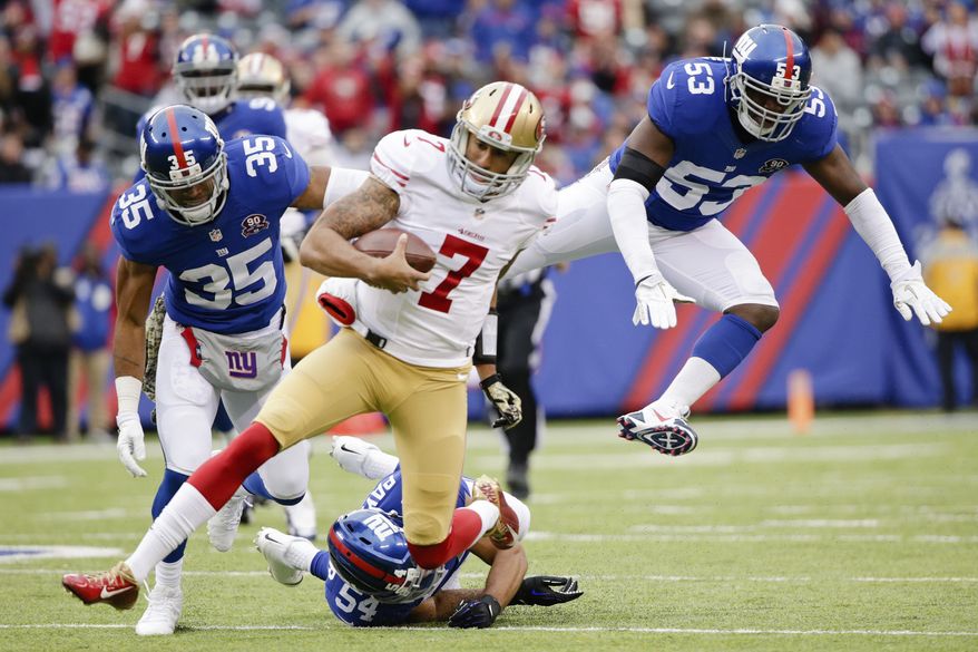 San Francisco 49ers quarterback Colin Kaepernick (7) avoids New York Giants middle linebacker Jameel McClain (53) and Quintin Demps (35) as he slides during the first half of an NFL football game Sunday, Nov. 16, 2014, in East Rutherford, N.J.  (AP Photo/Julio Cortez)