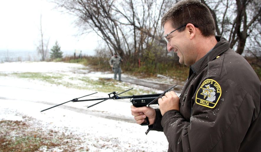In this Nov. 10, 2014, photo, Delta County Sheriff Ed Oswald locates a radio transmitter device by listening to frequency signals on a tracking unit during recent training for Project Lifesaver in Escanaba, Mich. The technology locates residents with cognitive disorders such as Alzheimer’s and autism who may be at risk to wander and don’t know they need help or can’t ask for help. (AP Photo/The Daily Press, Jenny Lancour)