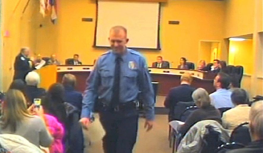 In this  Feb. 11, 2014, file image from video provided by the City of Ferguson, Mo., Officer Darren Wilson attends a city council meeting in Ferguson. (AP Photo/City of Ferguson, File)
