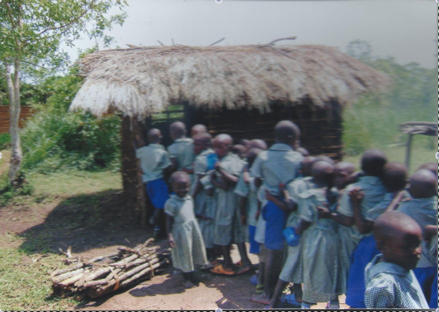 Children lined up for food outside a small hut at an orphanage in the jungle, 8 hours outside Kampala, Uganda. In the lower right corner is then-5-year-old Kinji. (Photo courtesy of the author.)