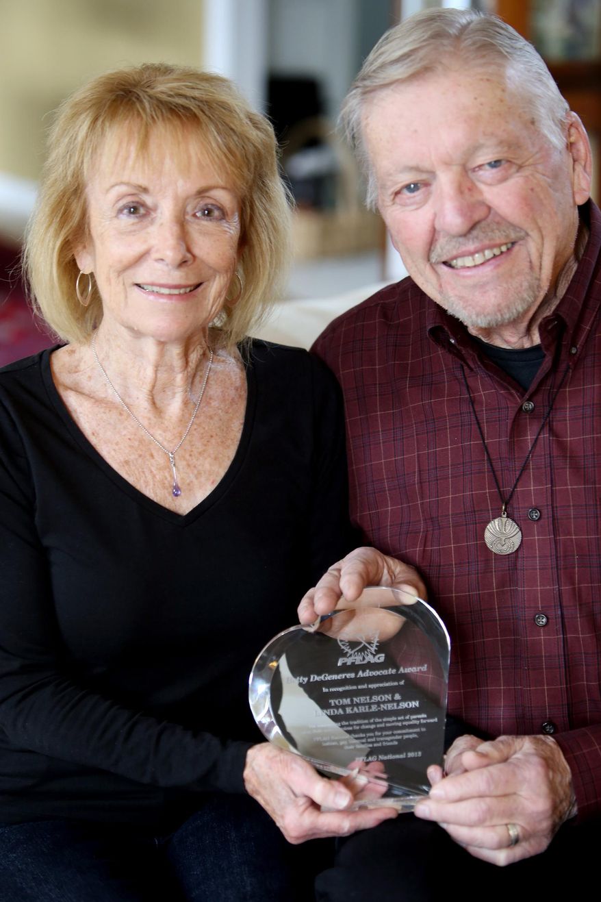 In this Thursday, Nov. 20, 2014 photo, Linda Karle-Nelson and Tom Nelson pose for a portrait with their PFLAG (formerly known as Parents, Families and Friends of Lesbians and Gays) award in Farmington Hills, Mich. Linda Karle-Nelson and Tom Nelson are parents of LGBT children and members of Fortunate Families, a support group for Catholic families with LGBT members. The Archdiocese of Detroit has banned Fortunate Families from using a Detroit parish for a meeting with a pro-gay rights speaker. (AP Photo/Detroit Free Press, Regina H. Boone)
