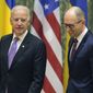 U.S. Vice President Joe Biden, left, talks with Ukrainian Prime Minister Arseniy Yatsenyuk during a meeting in Kiev, Ukraine, Friday, Nov. 21, 2014. (AP Photo/Efrem Lukatsky)