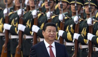 Chinese President Xi Jinping inspects a guard of honor outside the Great Hall of the People in Beijing, January, 2010. (Associated Press) ** FILE **