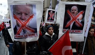 Turkish students stage a rally to protest against the visit of U.S. Vice President Joe Biden in Istanbul, Turkey, Saturday, Nov. 22, 2014.  Biden on Saturday called on Europe to continue diversifying its energy supplies to reduce dependence on Russia. (AP Photo)
