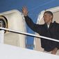 President Barack Obama waves as he deplanes from Air Force One, Sunday, Nov. 23, 2014, in Andrews Air Force Base, Md., as he returns form Las Vegas. (AP Photo/Carolyn Kaster)