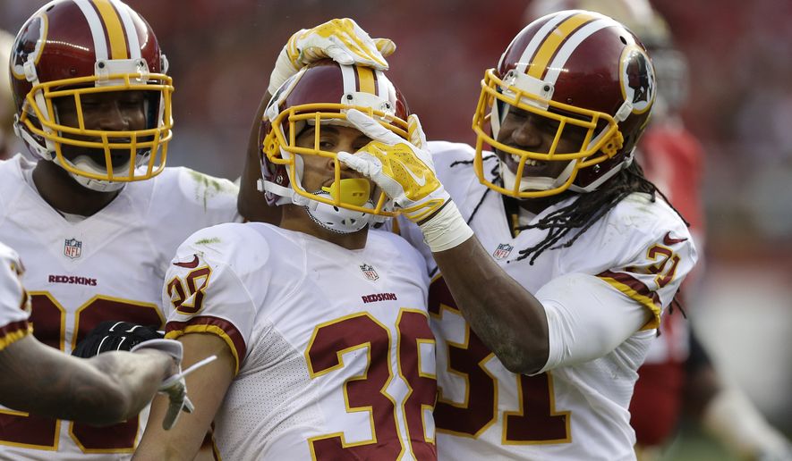 Washington Redskins cornerback Greg Ducre (38) celebrates after intercepting a pass with cornerback Bashaud Breeland, left, and strong safety Brandon Meriweather (31) against the San Francisco 49ers during the third quarter of an NFL football game in Santa Clara, Calif., Sunday, Nov. 23, 2014. (AP Photo/Ben Margot)